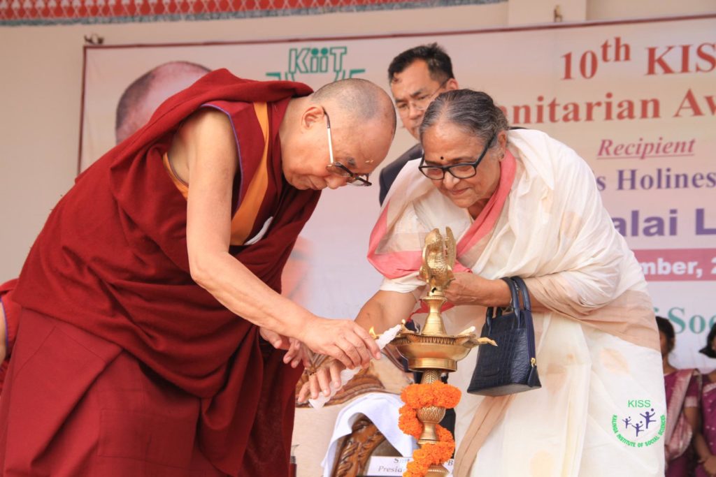 His Holiness The Dalai Lama lighting the traditional lamp at the ceremony.