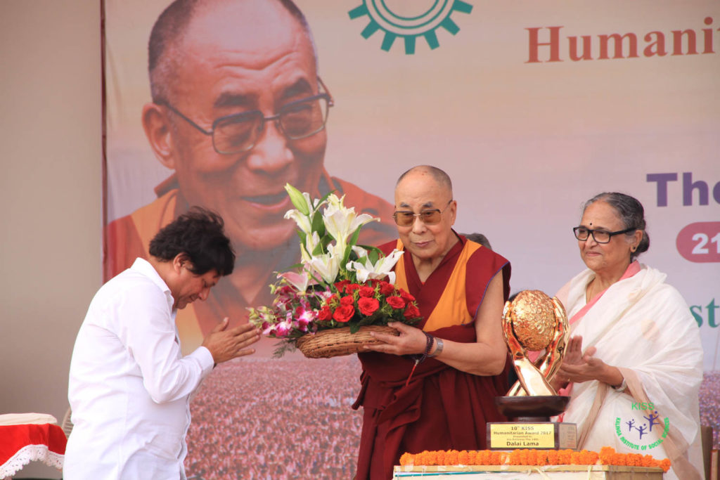 Prof. Achyuta Samanta presenting flowers to His holiness The Dalai Lama